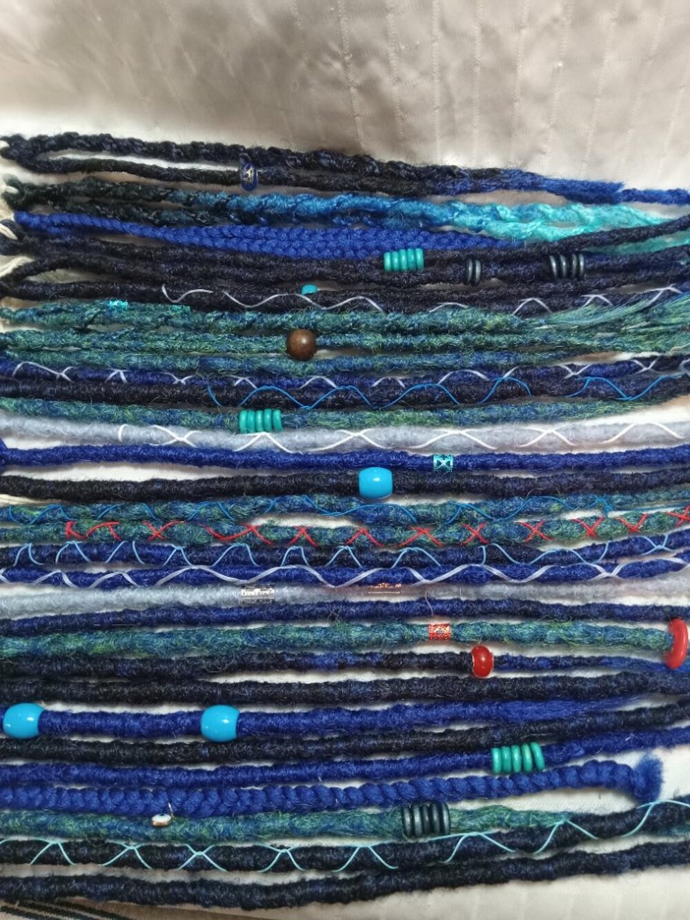 A full head of dreadlocks and braids, handmade from soft synthetic materials